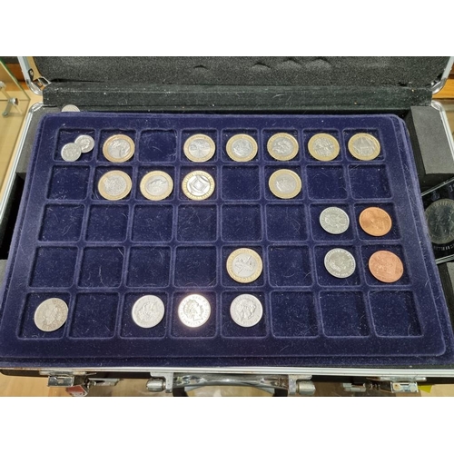 864 - Coins: a case of coins, to include: collectable fifty pence pieces; and two pound coins.... 