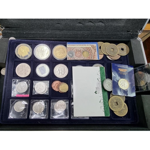 864 - Coins: a case of coins, to include: collectable fifty pence pieces; and two pound coins.... 