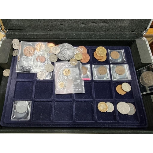 864 - Coins: a case of coins, to include: collectable fifty pence pieces; and two pound coins.... 