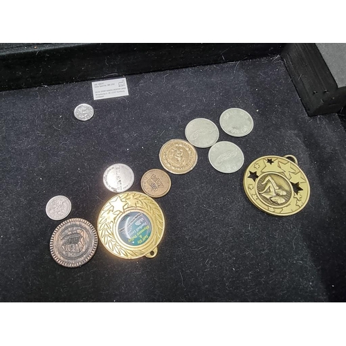 864 - Coins: a case of coins, to include: collectable fifty pence pieces; and two pound coins.... 