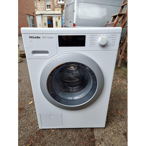 1036 - A Miele W1 classic washing machine, 84.5cm high x 60cm wide, with instruction manual.... 