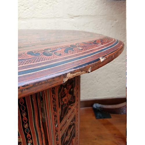 1201 - A red lacquer chinoiserie circular folding table, 46cm diameter. 