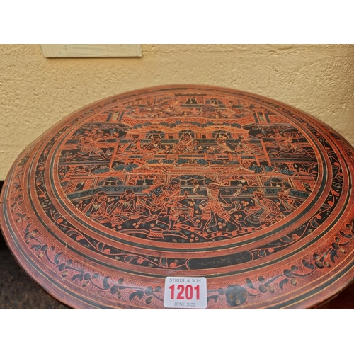 1201 - A red lacquer chinoiserie circular folding table, 46cm diameter. 