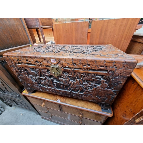 1218 - A Chinese carved camphor wood coffer, 93cm wide. 