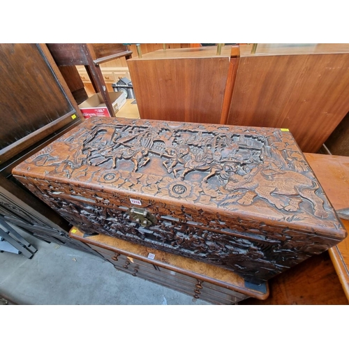 1218 - A Chinese carved camphor wood coffer, 93cm wide. 