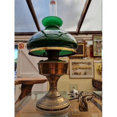 1229 - A brass and green glass table lamp, (electrified), height excluding chimney 41cm. ... 