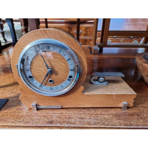 1238 - A 1930s pale oak mantel clock, chiming on four straight gongs, 35.5cm wide.