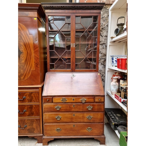 1243 - An interesting George III mahogany bureau bookcase, with carved frieze and fitted interior, 105... 