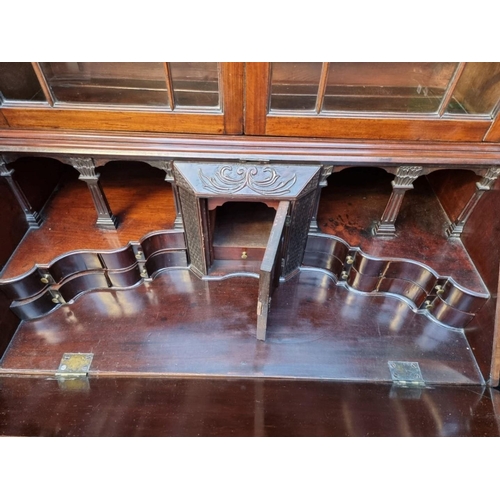 1243 - An interesting George III mahogany bureau bookcase, with carved frieze and fitted interior, 105... 