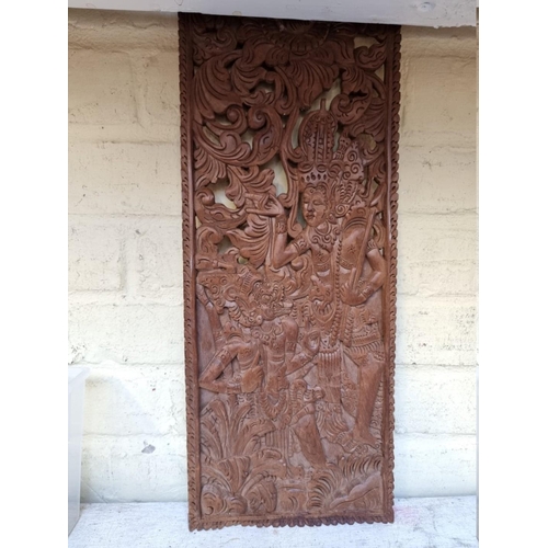 1289 - An antique mahogany wall mounted post box, 27cm wide; together with a Balinese carved wood panel.... 