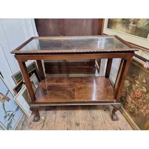 1362 - An early 20th century figured mahogany two tier whatnot, on ball and claw feet, 86cm wide.... 