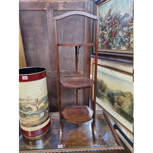 1364 - An early 20th century mahogany folding cake stand. 