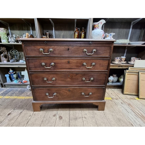 1419 - (ML) A small George III mahogany and crossbanded chest of drawers, with a brushing slide above four ... 