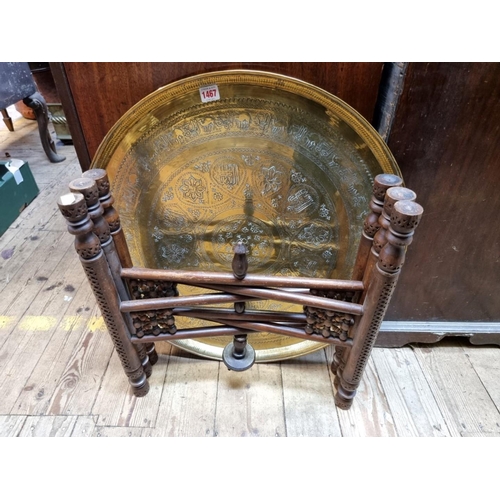 1467 - A large North African brass and mashrabiya folding table, 63cm diameter. 