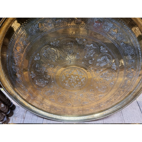 1467 - A large North African brass and mashrabiya folding table, 63cm diameter. 