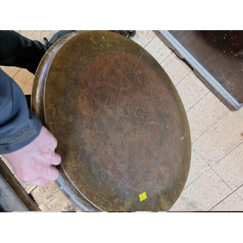 1467 - A large North African brass and mashrabiya folding table, 63cm diameter. 