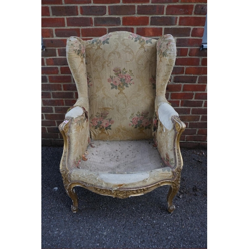 1469 - (ML) A late 19th century, Louis XV style, giltwood and upholstered wing armchair, with relief carved... 