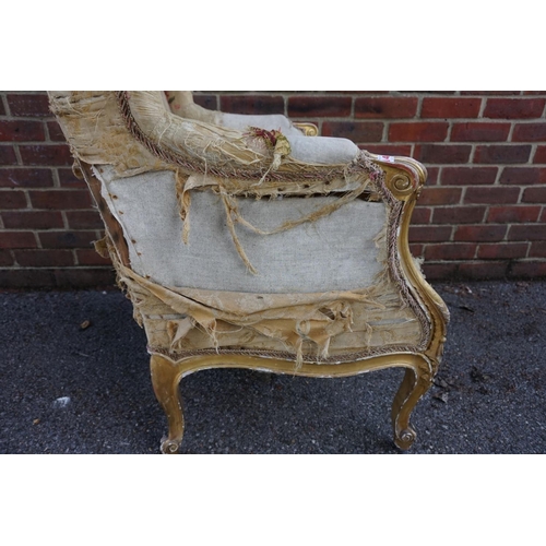 1469 - (ML) A late 19th century, Louis XV style, giltwood and upholstered wing armchair, with relief carved... 