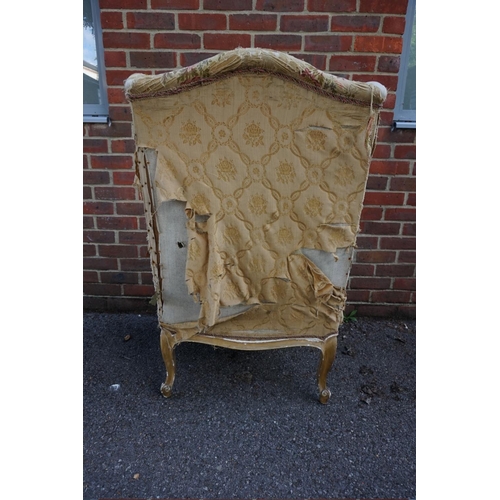 1469 - (ML) A late 19th century, Louis XV style, giltwood and upholstered wing armchair, with relief carved... 