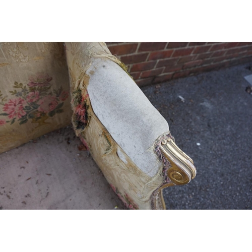 1469 - (ML) A late 19th century, Louis XV style, giltwood and upholstered wing armchair, with relief carved... 