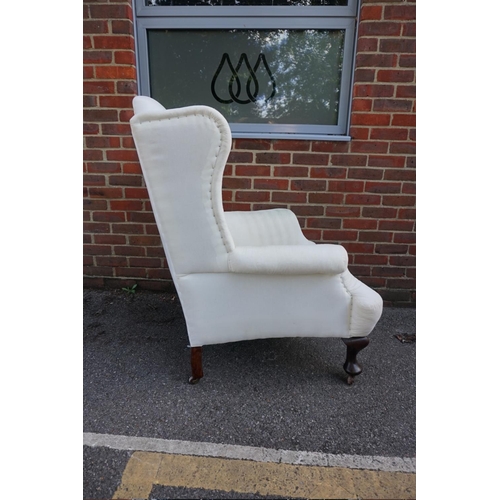 1472 - (ML) An antique wing armchair, on cabriole legs to the front. 