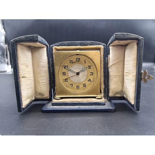 1490 - A small 1920s Zenith gilt metal alarm clock, 5.5cm high, in blue leather case.