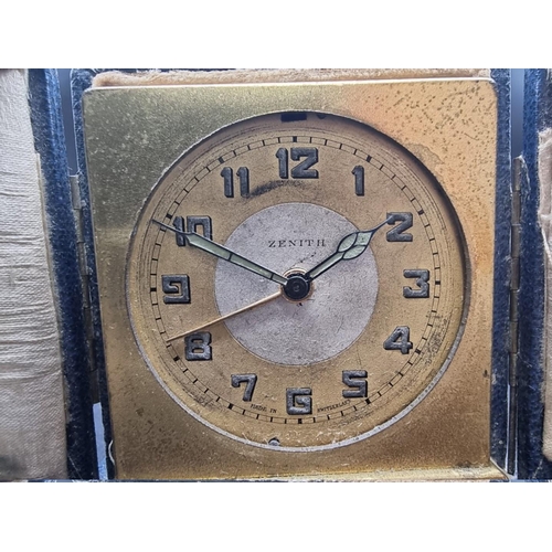 1490 - A small 1920s Zenith gilt metal alarm clock, 5.5cm high, in blue leather case.