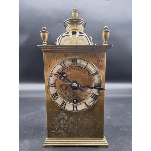 1496 - An old brass mantel clock, with engraved decoration, 21.5cm high.