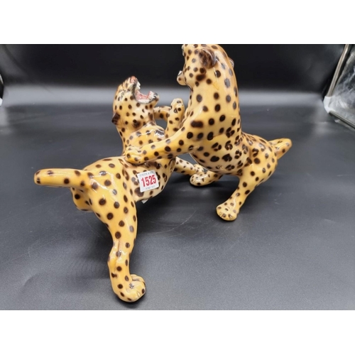 1525 - An Italian pottery figure group of two fighting leopards, 34cm wide. 