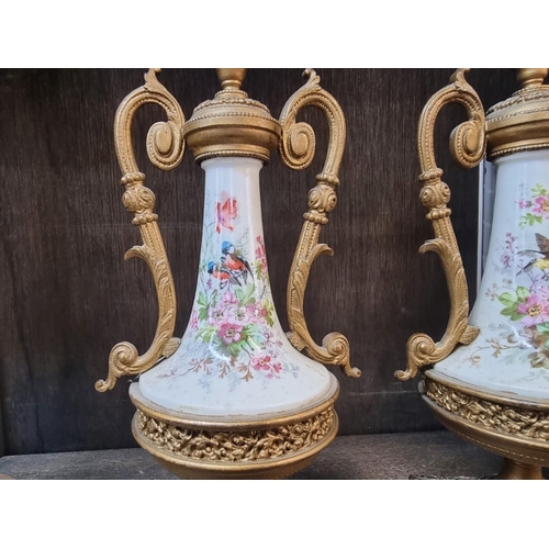 1550 - (ML) A pair of late Victorian gilt brass and porcelain twin handled side urns, each painte... 