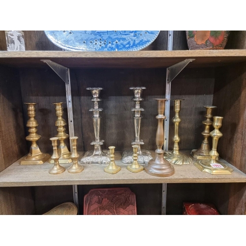 1553 - A collection of twelve antique candlesticks, to include four pairs, largest 25cm.  ... 