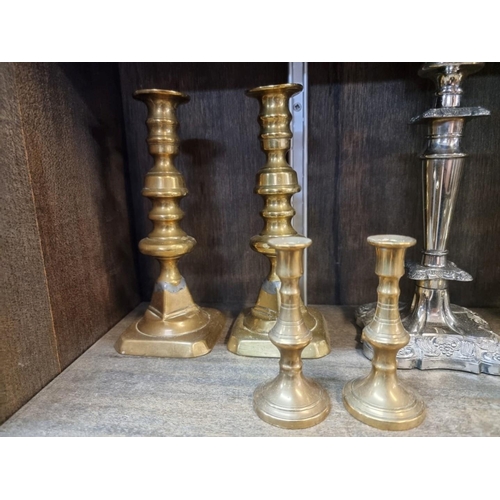 1553 - A collection of twelve antique candlesticks, to include four pairs, largest 25cm.  ... 