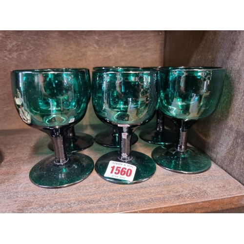 1560 - A set of six 19th century green glasses, 11cm high.