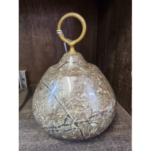 1568 - A serpentine doorstop, with brass ring handle, 16cm high. 