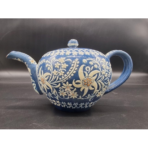 1580 - A Swiss Thun pottery teapot and cover, decorated with Edelweiss, 11.5cm high.