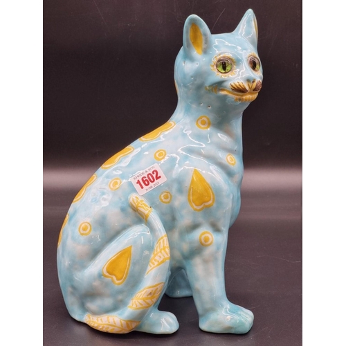 1602 - (ML) A Mosanic pottery cat, painted with yellow hearts on a turquoise ground, 31cm high.... 