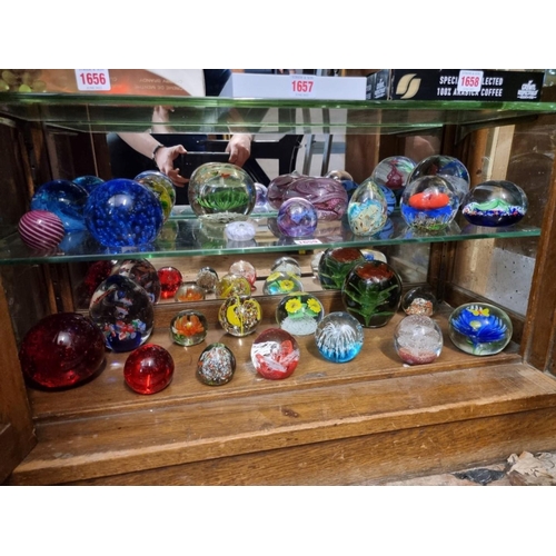 1659 - Twenty-six glass paperweights, to include examples by Caithness.