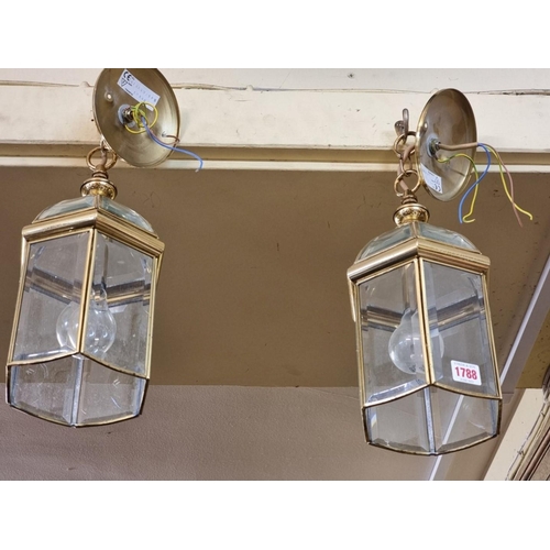 1788 - A small pair of brass and bevelled glass hexagonal ceiling lanterns, 33cm high.