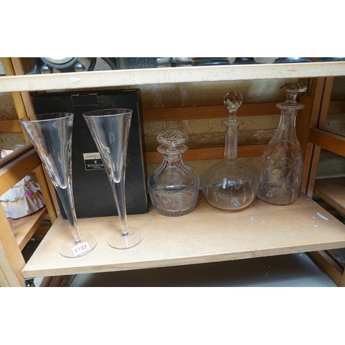 1187 - A pair of Waterford 'John Rocha' champagne flutes, boxed; together with three clear glass decanters ... 