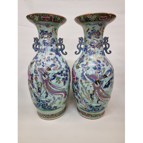 1773 - A large pair of Chinese famille rose celadon ground twin handled vases, decorated with pheasants and...