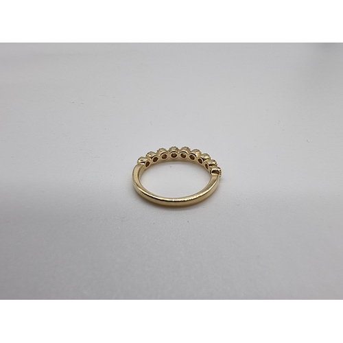 698 - A yellow metal diamond half eternity ring, stamped 14k, size N.