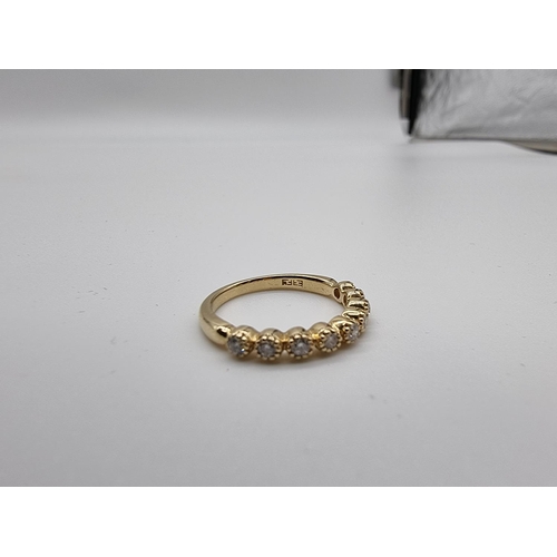 698 - A yellow metal diamond half eternity ring, stamped 14k, size N.