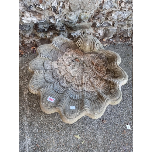 1055 - A reconstituted shell form bird bath.