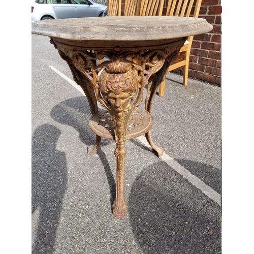 1056 - A cast iron pub table, having wooden top, 58cm wide x 70cm high.