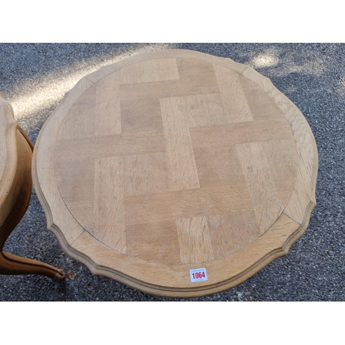 1064 - A pair of shaped coffee tables, 59cm wide x 70cm high. 