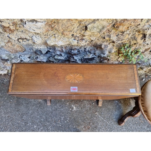 1065 - An Edwardian Sutherland table; together with a walnut piano stool. 