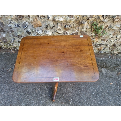 1068 - A 19th century mahogany rectangular tripod table, 52cm wide x 70cm high. 