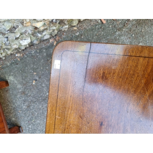 1068 - A 19th century mahogany rectangular tripod table, 52cm wide x 70cm high. 