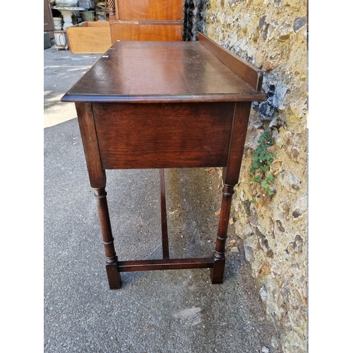 1069 - A Waring & Gillow two drawer side table, 114cm wide x 82cm high x 52cm deep.