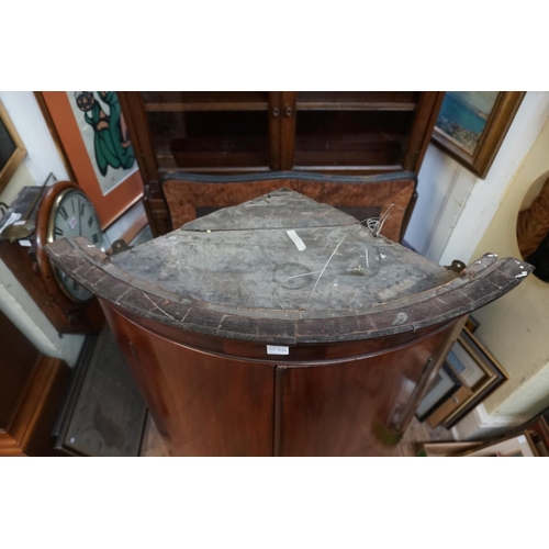 1070a - A George III mahogany bowfront hanging corner cupboard.